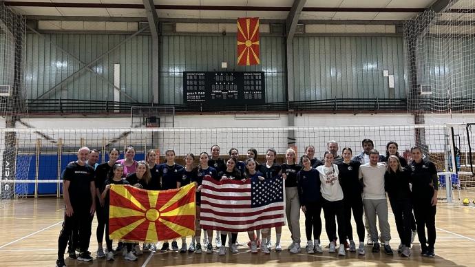 the 澳门金沙线上赌博官网 delegation and North Macedonian host representatives posed for a photo in a gym, holding up a USA flag and a North Macedonian flag